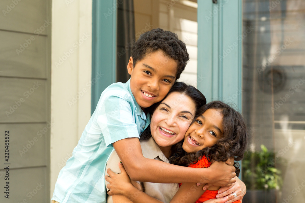 Happy Hispnaic mother laughing and talking with her children. Happy Hispnaic mother laughing and talking with her children.