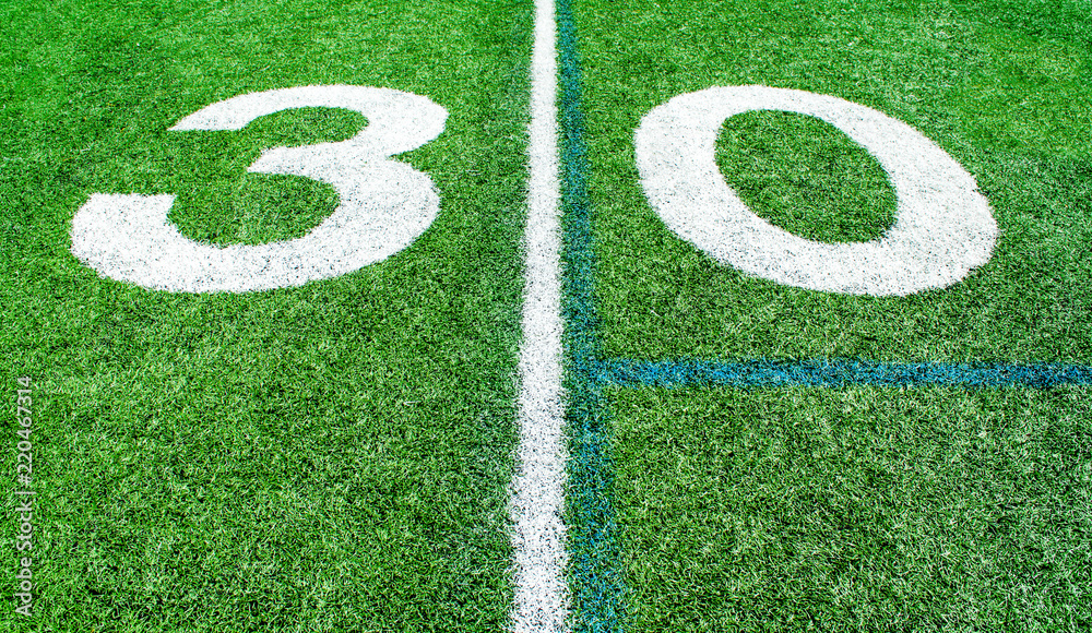 numbers marking the 30 yard line on an American football field numbers marking the 30 yard line on an American football field