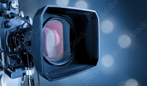 Close-up of a television camera lens on blurred background