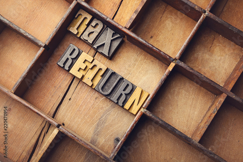 Tax return in wooden typeset letters photo