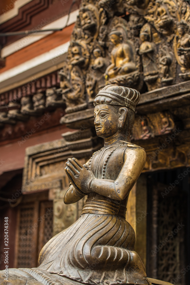 The ancient bronze statue sitting in front of Golden Temple (Kwa Bahal) in Patan, Nepal.
