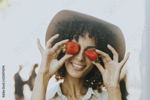 Woman having fun with strawberries