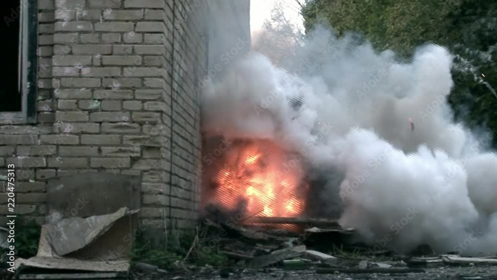 Explosion of hand grenades in destroyed house. Airsoft sports game using a copy of a firearm. Explosion of hand grenades in destroyed house. Airsoft sports game using a copy of a firearm.