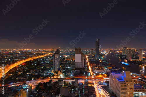night urban metropolis cityscape with light tail on road