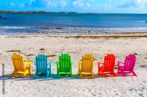 Colorful chairs at sandy beach