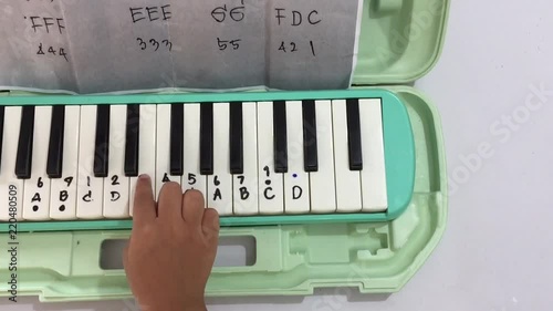  Child playing melodian photo