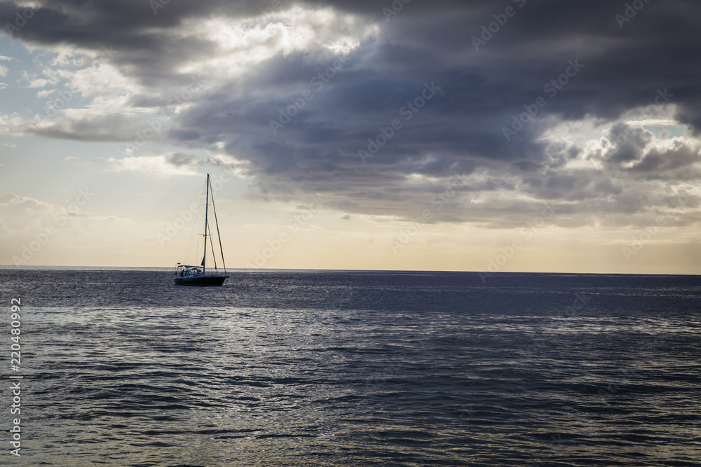 Evening view of sailboat from the beach of Oahu island, Hawaii