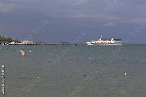 Ship Yanina approaches the pier of the central beach of the resort city Evpatoria, Crimea, Russia