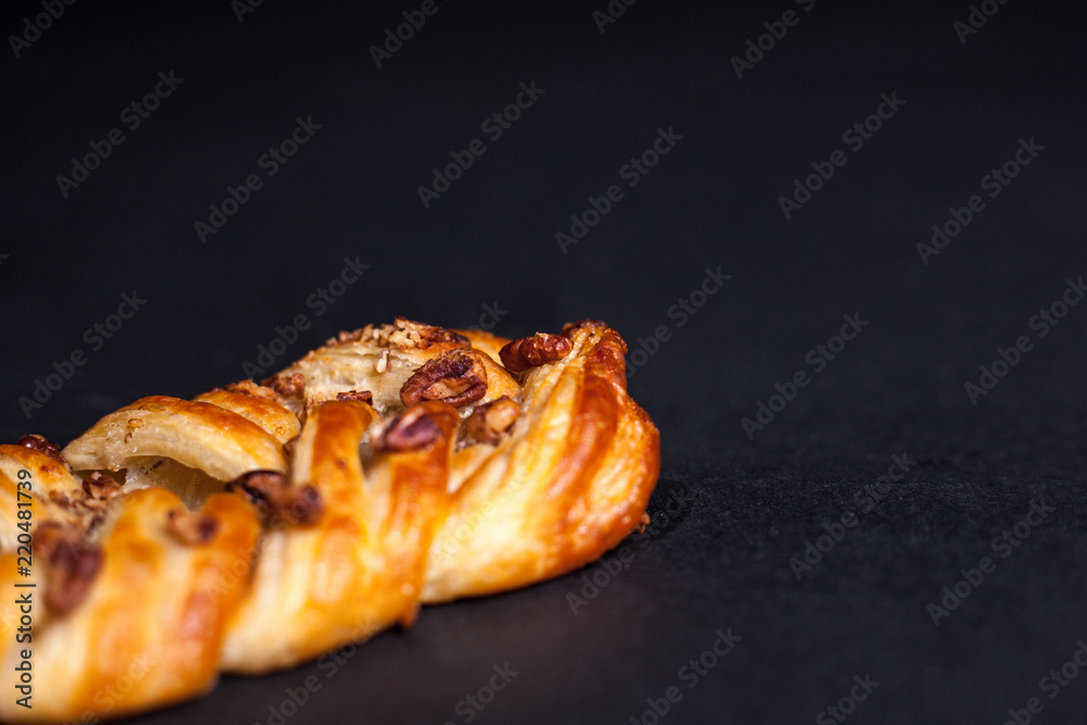 Bun with nuts and jam on a black background Bun with nuts and jam on a black background
