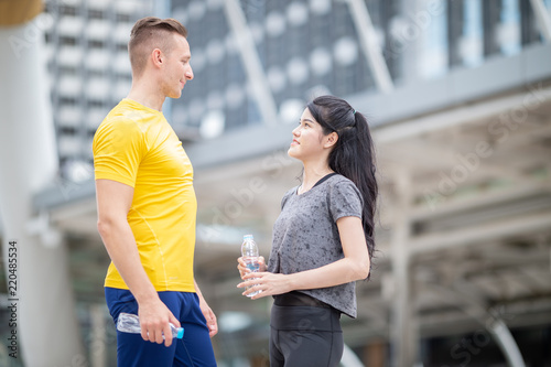 Young couple talking after exercise in the City street