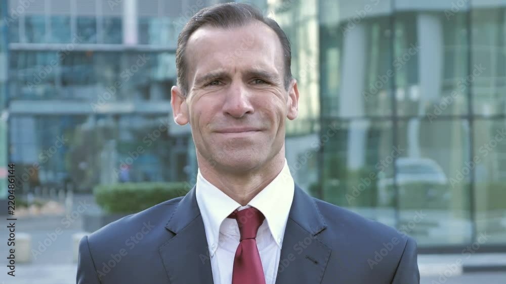 Portrait of Sad Middle Aged Businessman Looking at Camera Portrait of Sad Middle Aged Businessman Looking at Camera