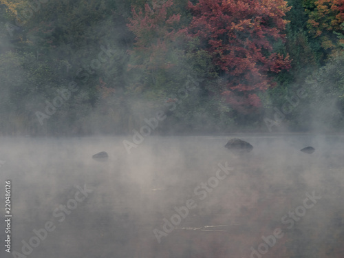 This is a picture of autumn leaves at Mont-Tremblant in the Laurentian plateau in Quebec, Canada. It is a lake on the outskirts of Mont-Tremblant. The morning mist is fantastic.