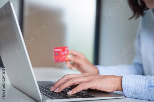 Online payment,Woman's using computer laptop and hand holding credit card for online shopping.