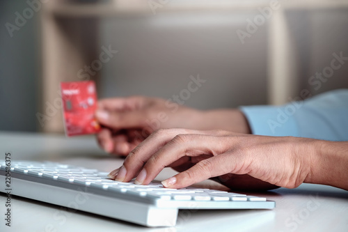 Online payment,Woman's touch keyboard pad and hand holding credit card for online shopping.