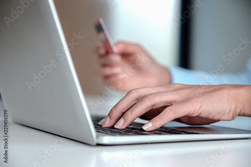 Online payment,Woman's using computer laptop and hand holding credit card for online shopping.