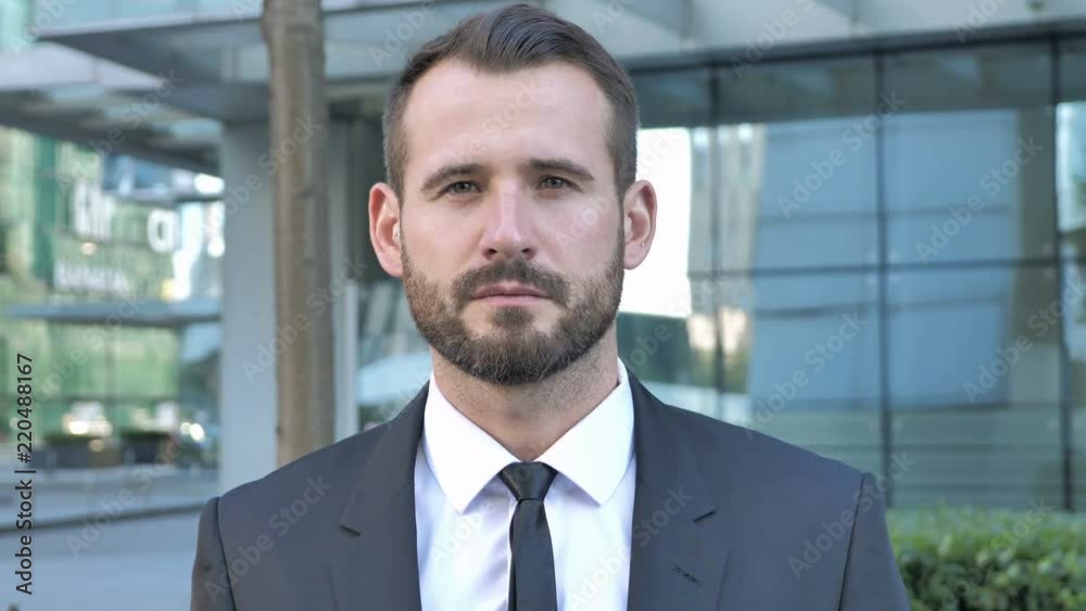 Portrait of Serious Businessman Looking at Camera Portrait of Serious Businessman Looking at Camera