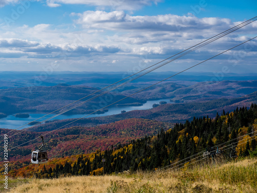 This is a picture of autumn leaves at Mont-Tremblant in the Laurentian plateau in Quebec, Canada. It is a scenery from Mont-Tremblant mountain. It is very beautiful with red and orange.