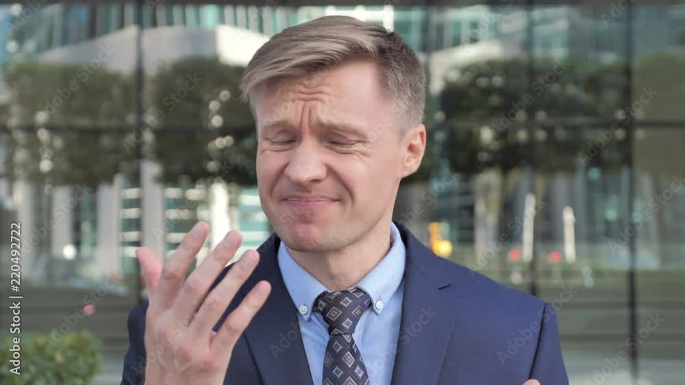 Businessman Upset by Loss Ouside Office Businessman Upset by Loss Ouside Office