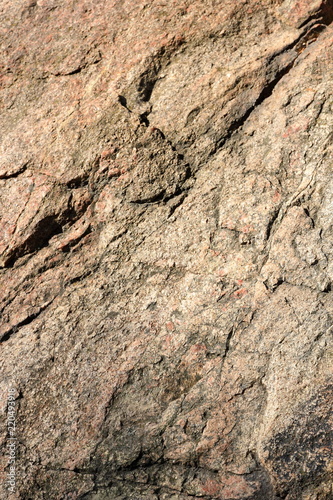Granite background. Granite stone close up. Texture of natural material. Rocky rocks of ancient times. Natural pattern
