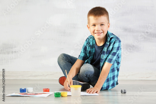 Cute boy painting picture o...
