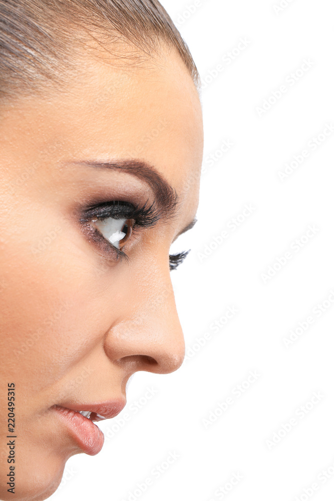 Fototapeta premium Beautiful young woman with eyelash extensions on light background, closeup