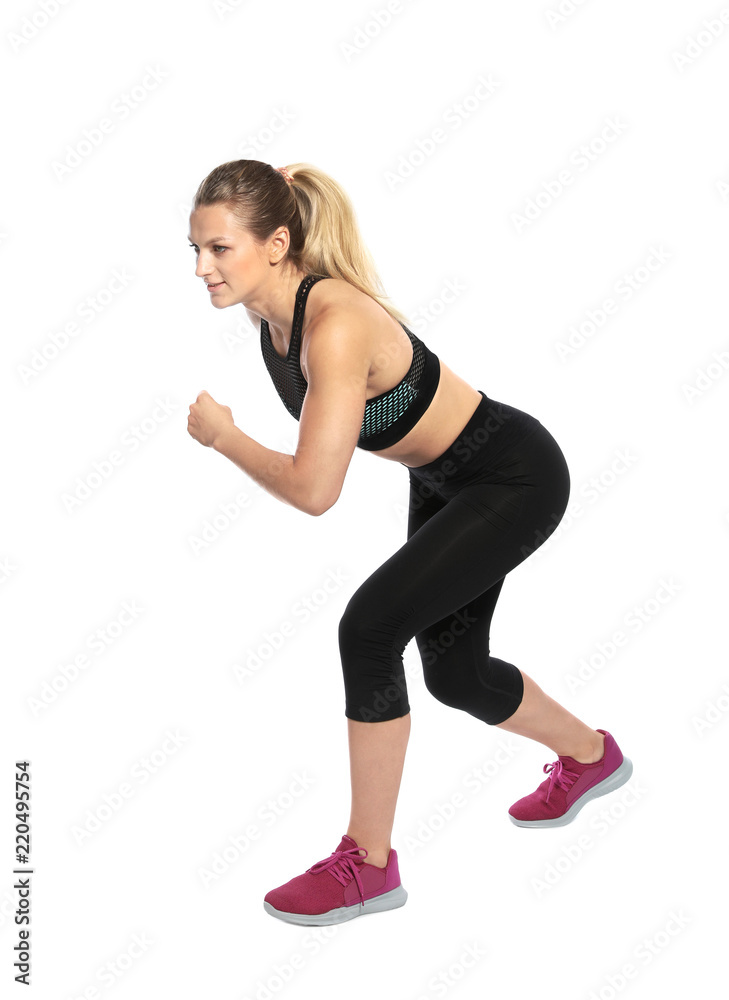 Young woman ready to run on white background