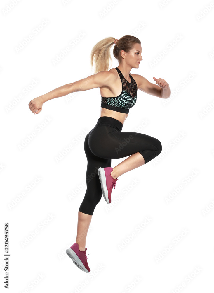 Sporty young woman running on white background