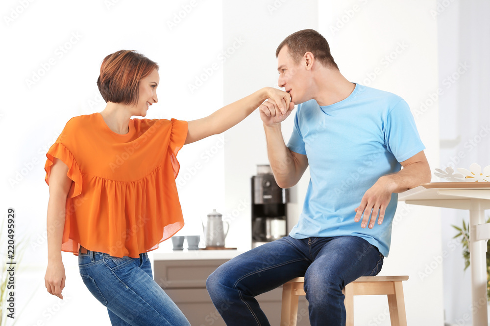 Young man kissing hand of his beloved girlfriend at home Young man kissing hand of his beloved girlfriend at home