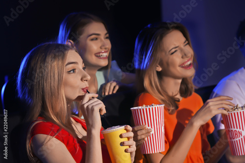 Young women watching movie ...