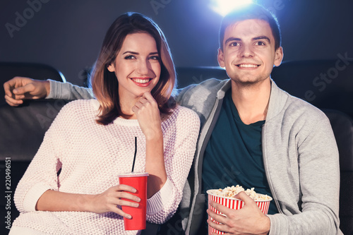 Young couple watching movie...