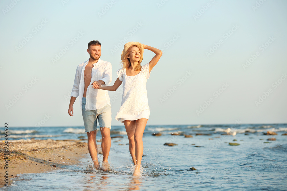 Young couple spending time together on beach Young couple spending time together on beach