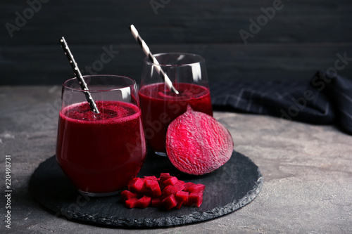 Fototapeta Naklejka Na Ścianę i Meble -  Slate plate with glasses of beet smoothies on table