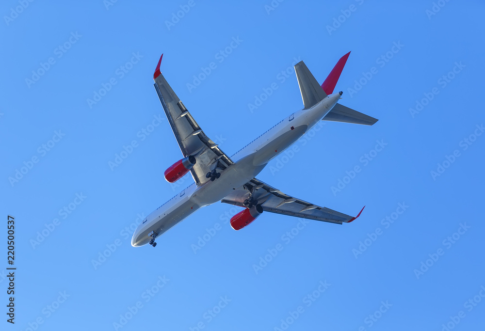plane with landing gear against the blue sky plane with landing gear against the blue sky