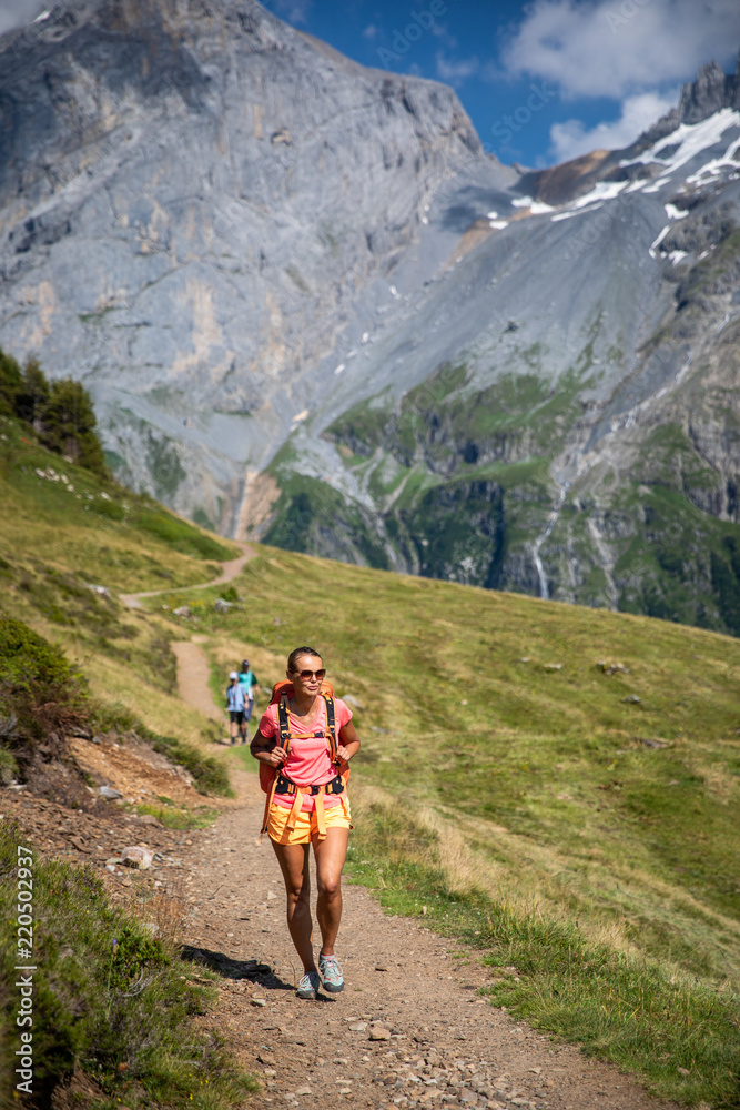 Pretty, female hiker/climber in a lovely alpine setting of Swiss Alps