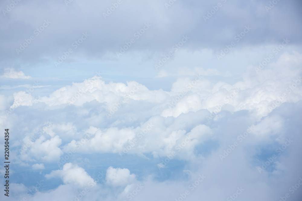 Naklejka premium cloudy and blue sky for background. nature background white cloud and blue sky view from airplane windows. Beautiful view of clouds and sky from a plane window.