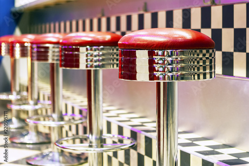 Vintage Row of metal bar stools, interior, red metal chairs near the bar.