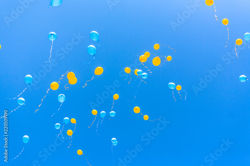 Yellow and blue balloons in the sky