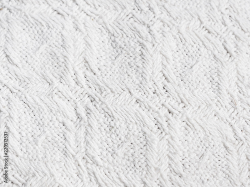Texture of hand-woven white fabric. Rough threads, prominent textile pattern.