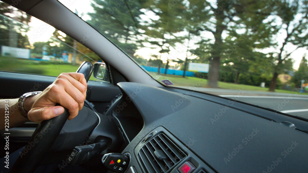 Man driving a car moving fast on a highway (motion blurred image)