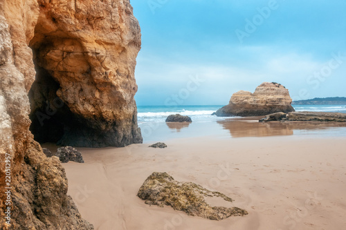 beautiful ocean landscape, the coast of Portugal, the Algarve, rocks on the sandy beach, a popular destination for travel in Europe
