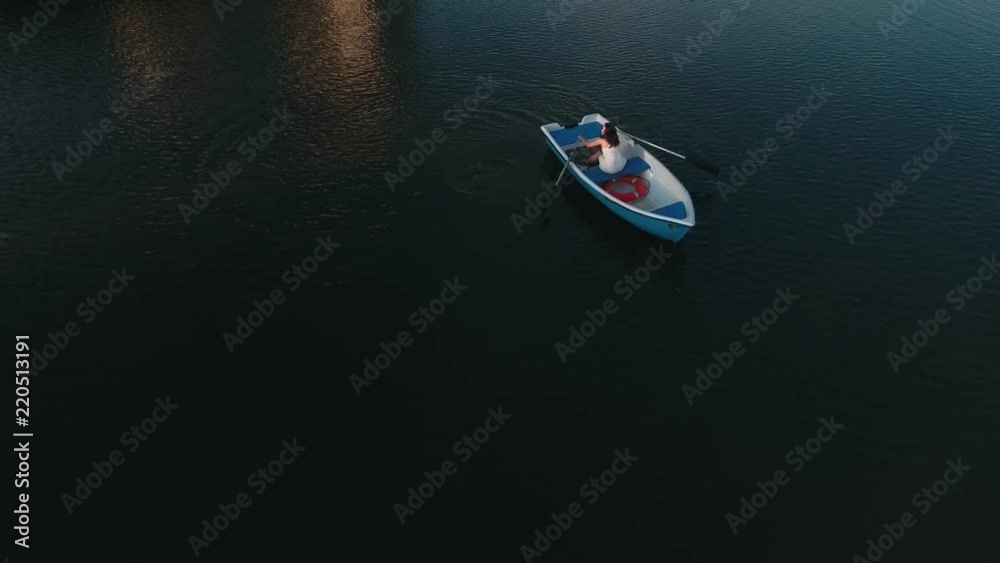 Young girl boating on the lake Young girl boating on the lake