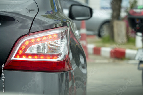 Back lights of grey car,While flaming red. © Nattaro