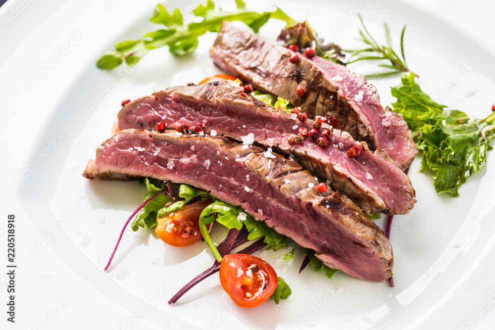 Close-up juicy flank steak from vegetable salad. Close-up juicy flank steak from vegetable salad.