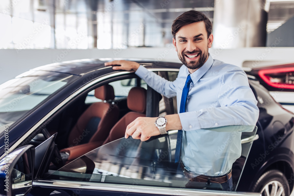 salesman standing at the car salesman standing at the car