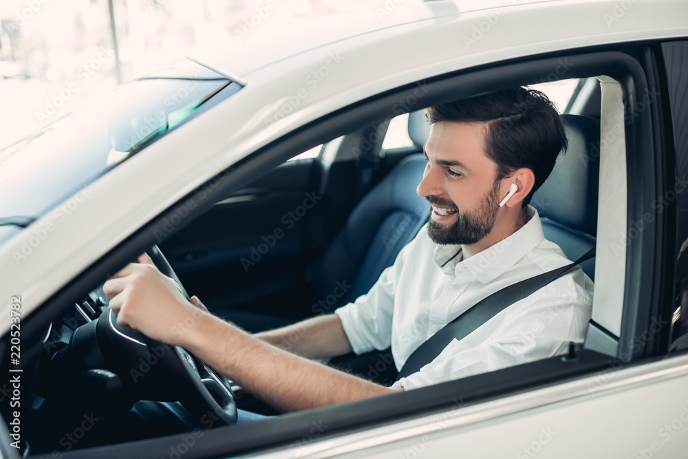 man with fasten safety belt driving a car