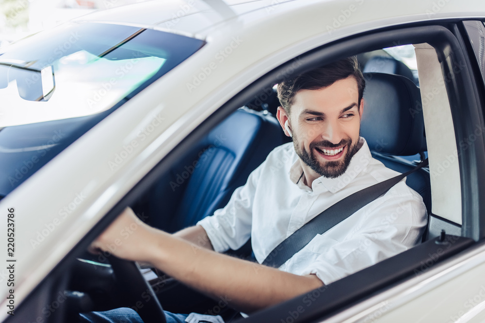 man with fasten safety belt driving a car man with fasten safety belt driving a car