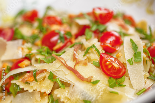 Pasta with prosciutto, parmesan cheese, cherry tomatoes macrophotography