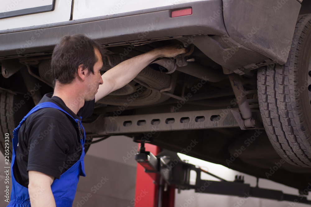 Technician working in the auto service Technician working in the auto service