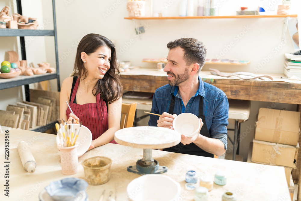 Couple Having Fun During Pottery Date In Workshop Couple Having Fun During Pottery Date In Workshop