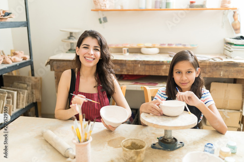Mother And Daughter Showing Their Innovative Pottery Painting Techniques